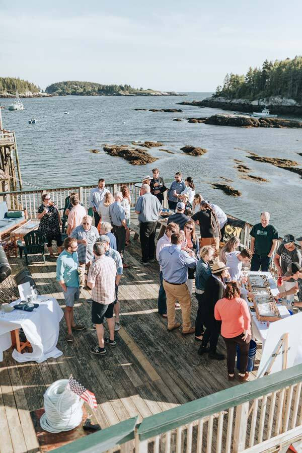 Guests gathered on the waterfront deck at Basecamp