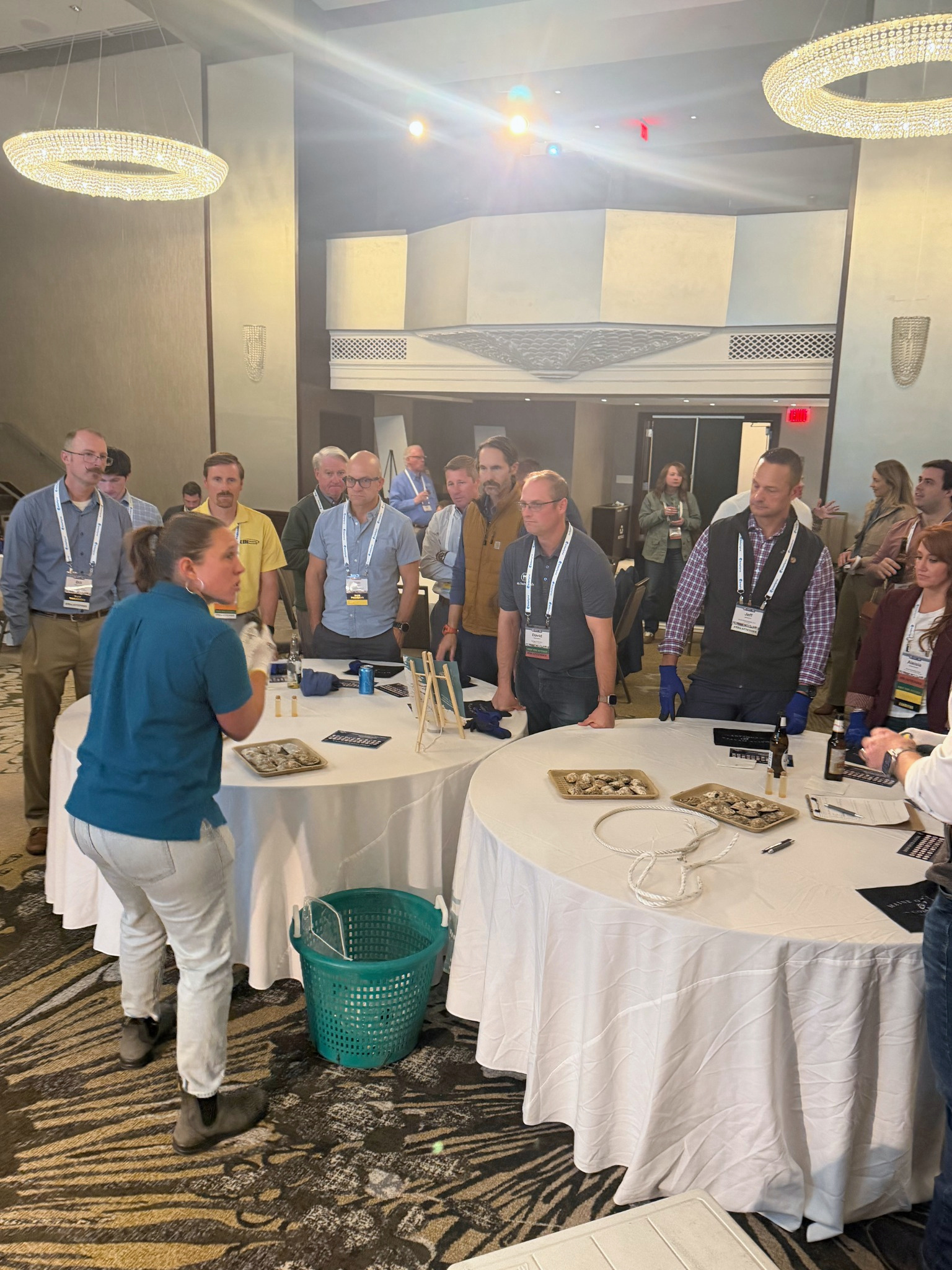 Guests learning to shuck oysters together at a corporate event